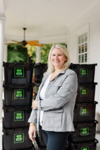 Kourtney owner of Bins On The Move standing with reusable moving bins