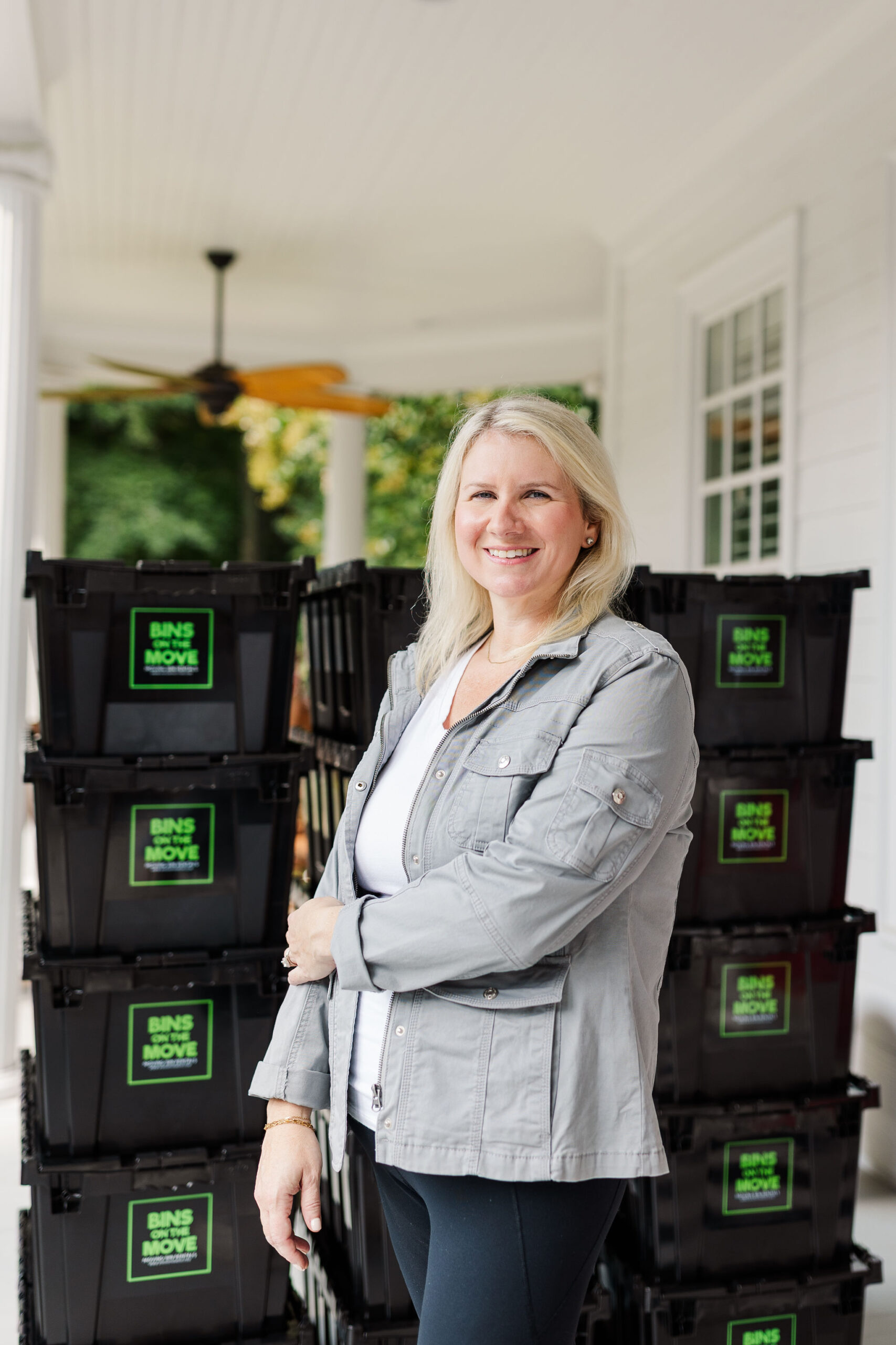 Kourtney owner of Bins On The Move standing with reusable moving bins