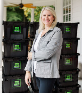 Kourtney owner of Bins On The Move standing with reusable moving bins