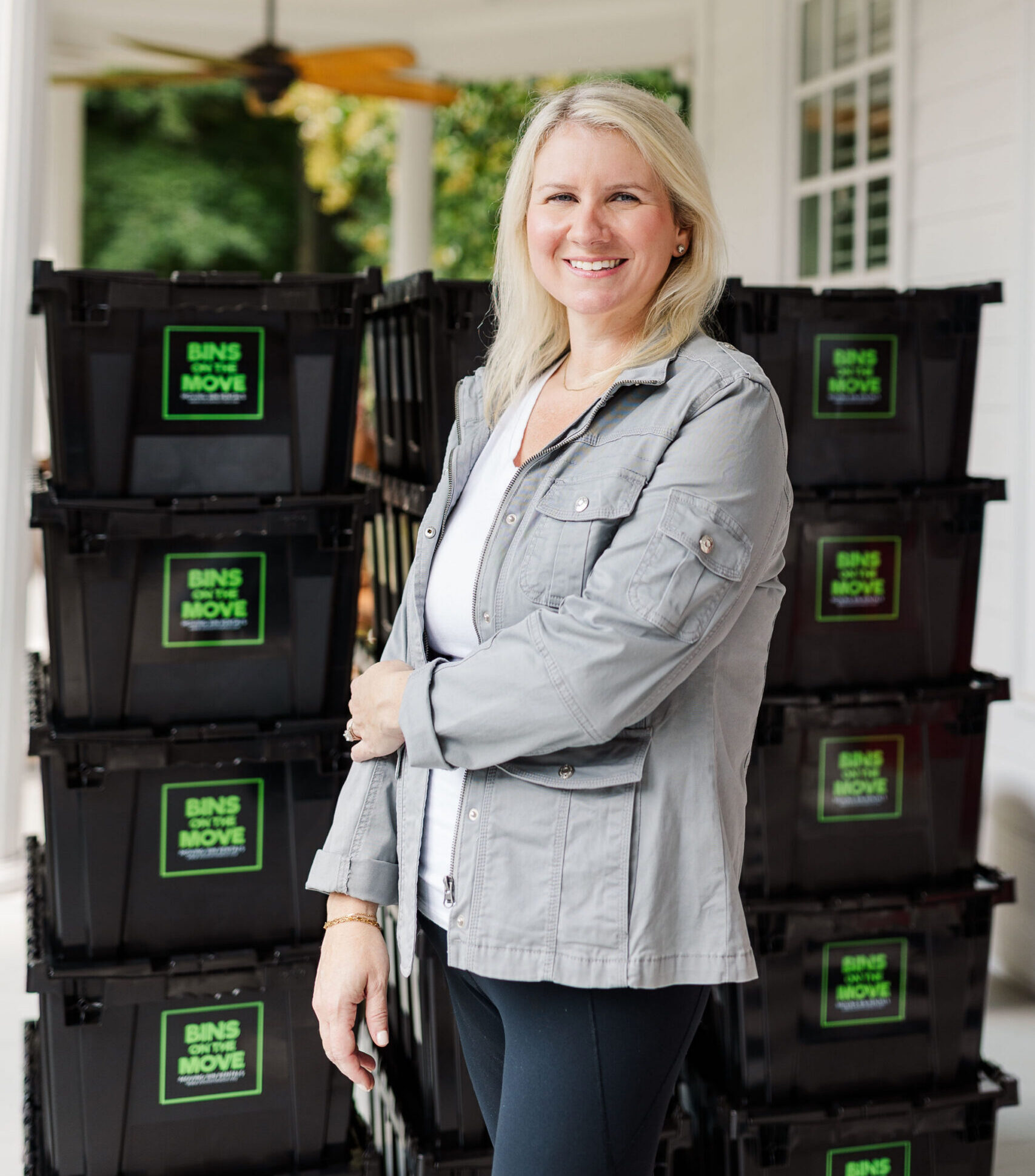 Kourtney owner of Bins On The Move standing with reusable moving bins